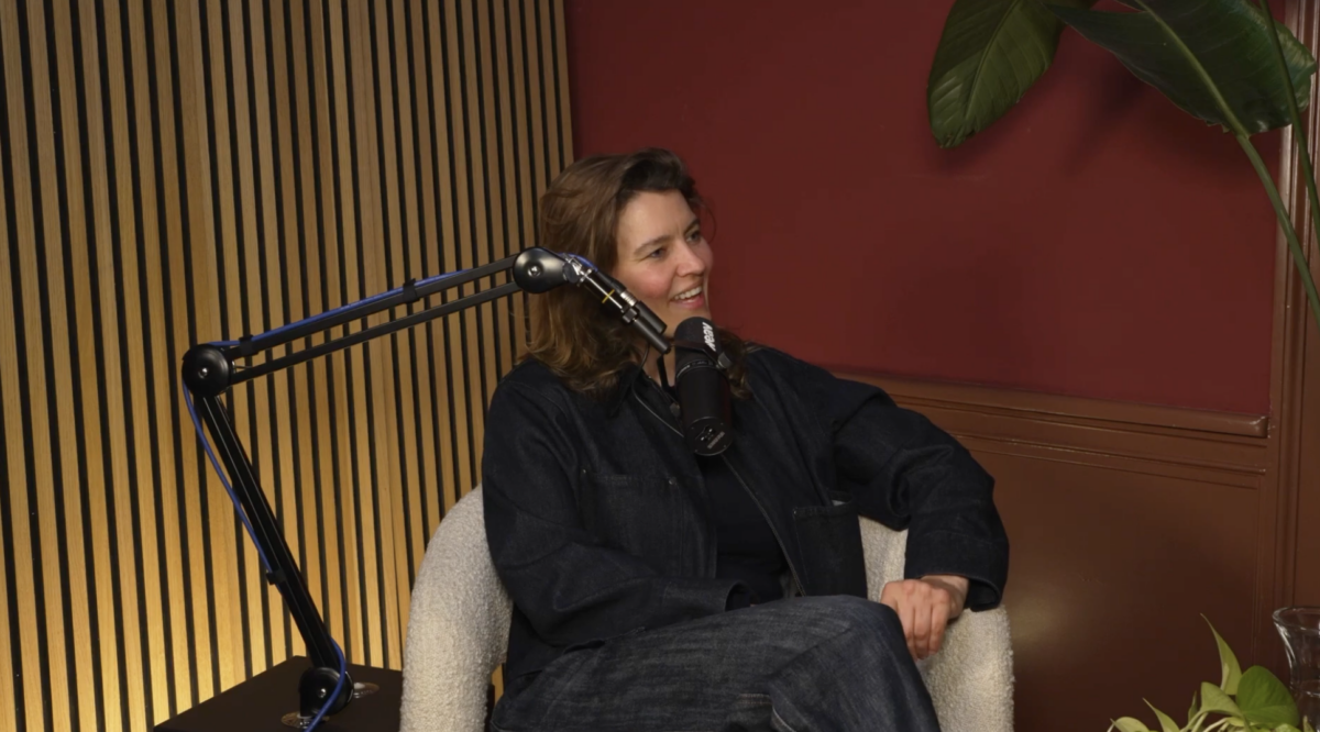 Jacqueline sitting on a chair and talking in the microphone